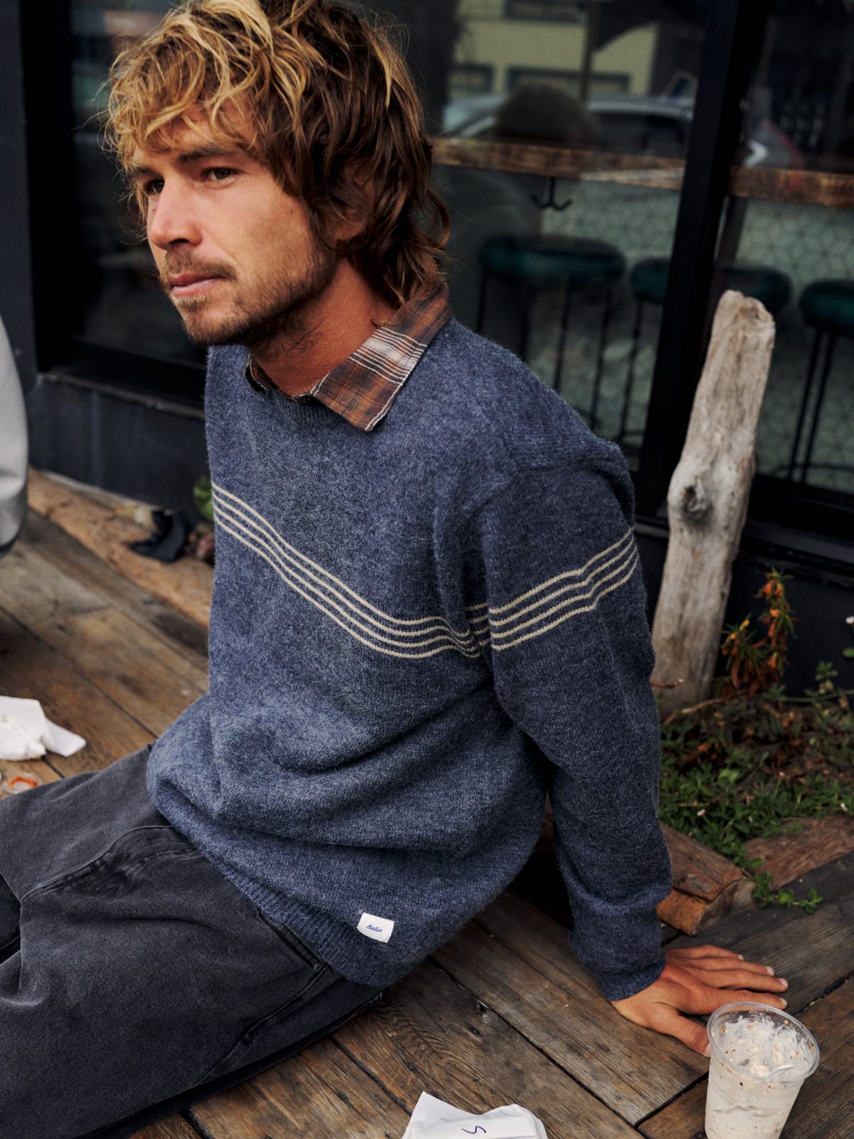 Katin Charles Sweater in Navy with cream chest stripes, worn over a plaid shirt, lifestyle